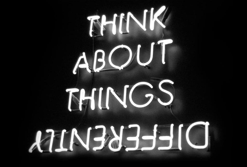 Image of neon wording, Think About Things Differently